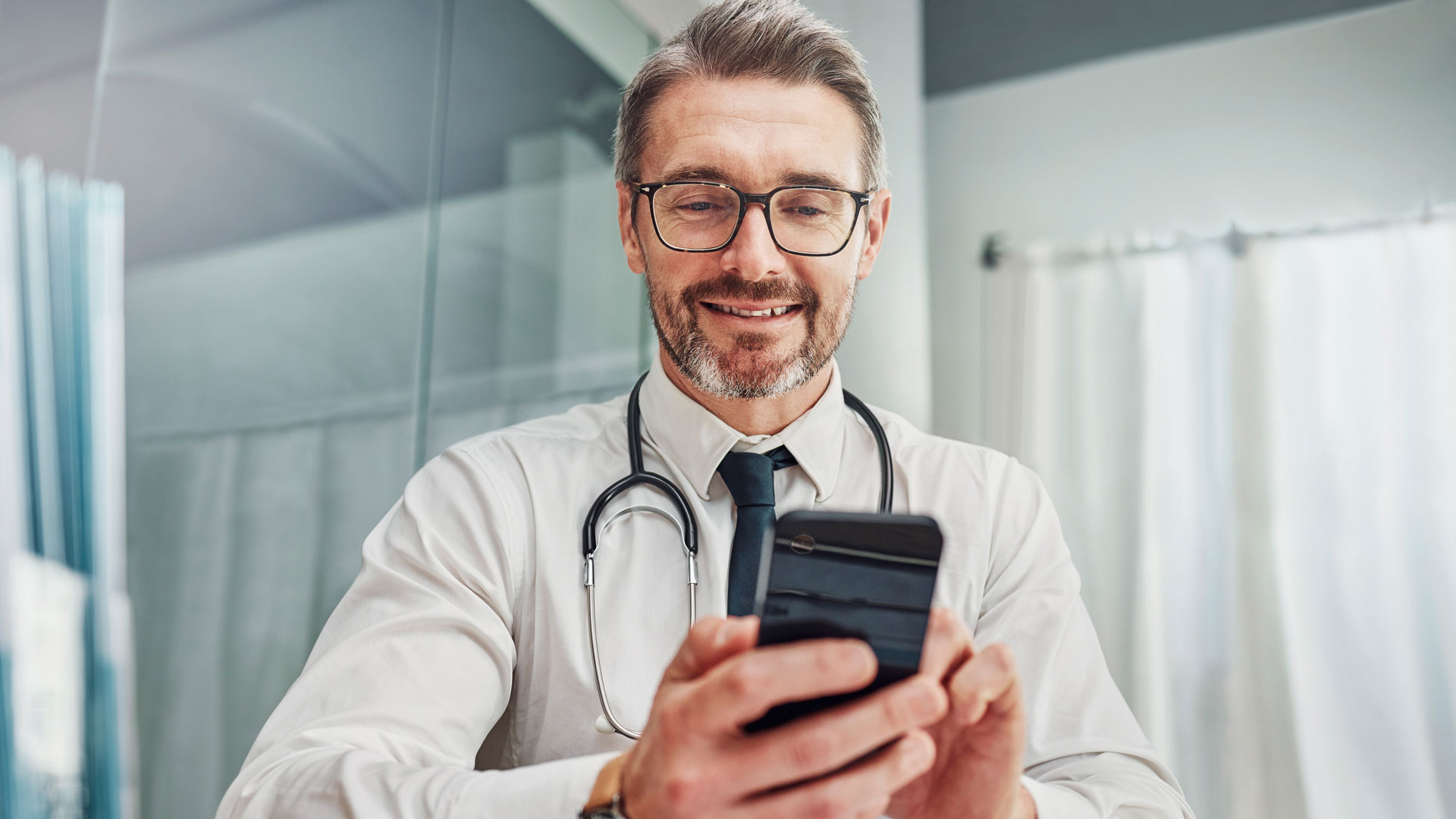 Healthcare, smile and doctor with smartphone at desk for wellness research, m360 Research, Better Screeners, Better Results